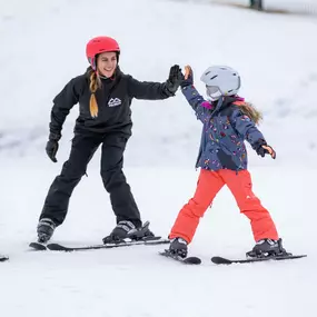 High fives and good times learning the skiing basics.