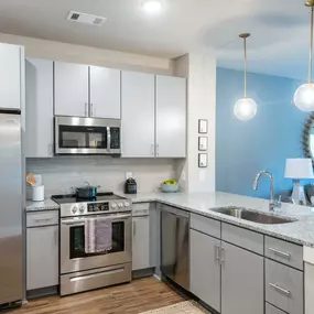 a kitchen with stainless steel appliances and a counter top