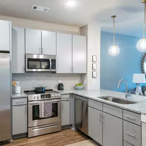 a kitchen with steel appliances and a counter top