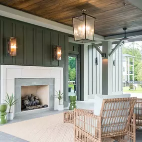 a covered patio with a fireplace