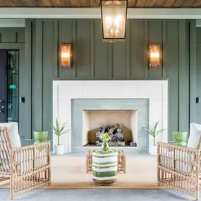 an outdoor patio with a fireplace and tables and chairs