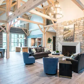 a large living room with couches and chairs and a fireplace