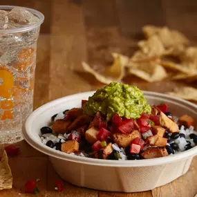 A burrito bowl topped with freshly grilled adobo chicken brings the flavor!