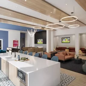 Modern resident lounge with large windows, cozy seating, and stylish pendant lighting.