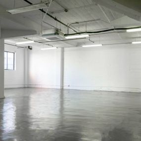 empty room with white walls and concrete floor