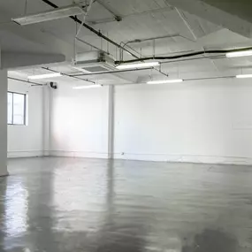 empty room with white walls and concrete floor at Binford Lofts in Los Angeles, CA 90013