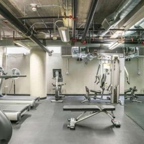 A gym with weights and cardio equipment in a building