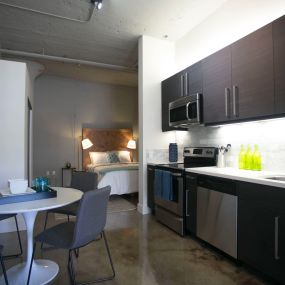 A kitchen and dining area in a studio apartment