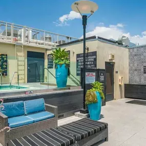 Outdoor view of the pool area of a building featuring the spa and lounge chairs