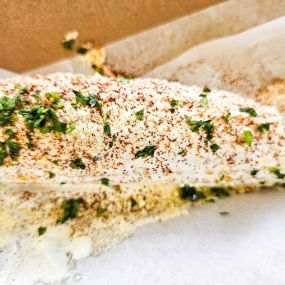 Elote.  Local fresh sweet corn, grilled and served with sour cream chipotle crema with cilantro  & cotija cheese.