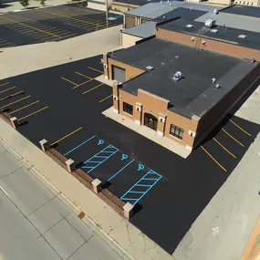 Aerial View of a Commercial Building With a Freshly Paved Parking Lot