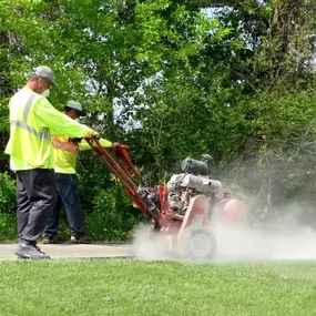 asphalt seal & repair employees repairing pavement