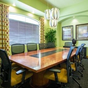 a conference room with a long wooden table and chairs at Canyon Crossroads