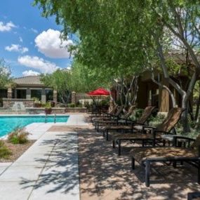 a pool with chairs and trees next to it at Canyon Crossroads