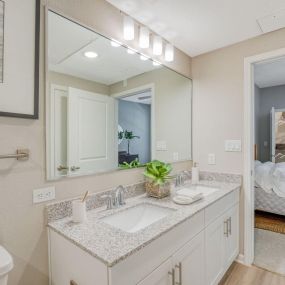 a bathroom with two sinks and a large mirror