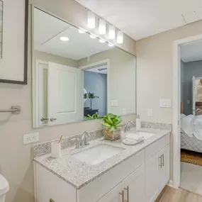 a bathroom with two sinks and a large mirror