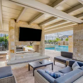 a living room with a fireplace and a television