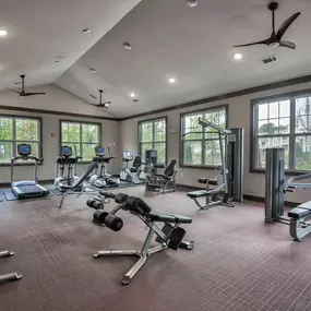 the gym has plenty of exercise equipment and windows at Sterling Creek