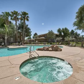 a pool with a hot tub and a swimming pool with trees at Desert Sage