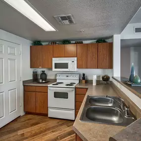 a kitchen with a stove microwave and a sink at Desert Sage