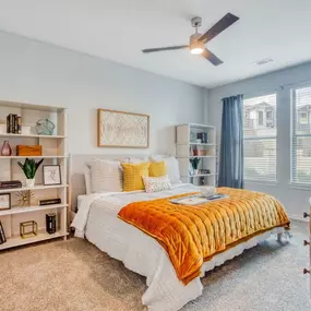 a bedroom with a bed and a ceiling fan