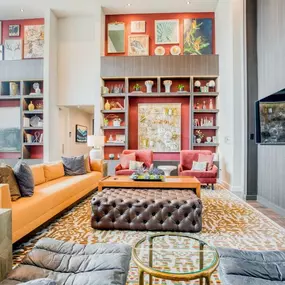 a living room filled with furniture and a book shelf