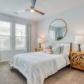a bedroom with a bed and a mirror
