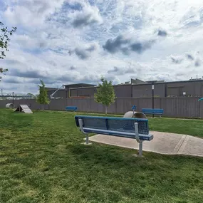 a park bench sitting in the middle of a field at Legacy Flats