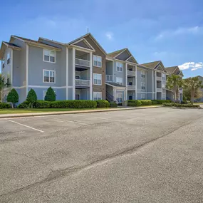 an empty parking lot in front of an apartment building at Spring Creek Apartments