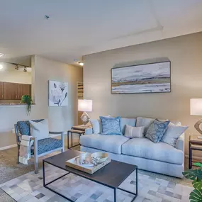 a living room with a couch and a table at Spring Creek Apartments