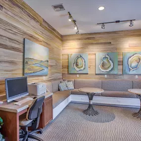 a living room with furniture and a computer on a desk at Spring Creek Apartments