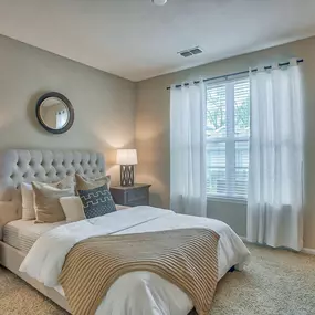 a bedroom with a large bed and a window at Spring Creek Apartments