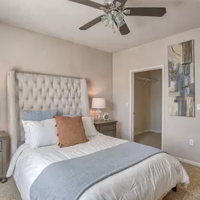 a bedroom with a bed and a ceiling fan at Spring Creek Apartments