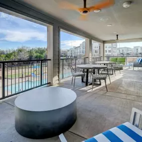 a large balcony with tables and chairs and a view of the city at The Jane at Preston Trail