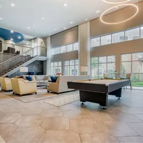 a large living room with a piano and a spiral staircase