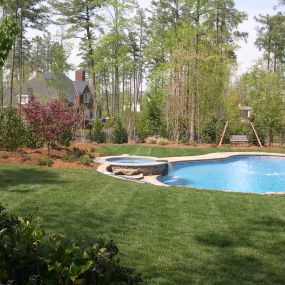 A newly constructed pool, spa, and patio, complete with landscape beds.