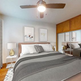 a bedroom with a bed and a ceiling fan