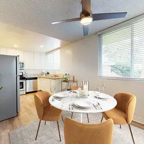 an open kitchen and dining room with a white table and chairs