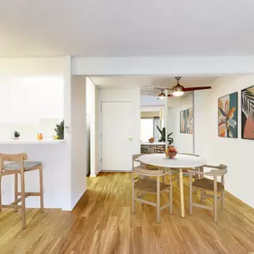 Dining area, kitchen, and living room at Village Pointe Apartment Homes