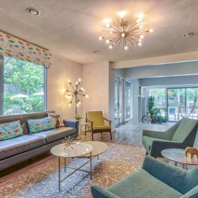 a living room with couches and chairs and a chandelier