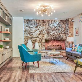 a living room with a stone walled fireplace