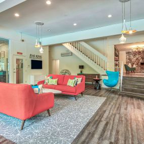 a living room with furniture and a staircase