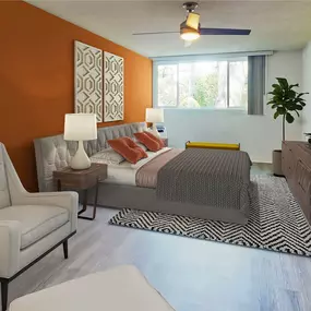 a bedroom with an orange accent wall and a bed