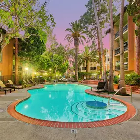 the swimming pool at night at the apartments for rent