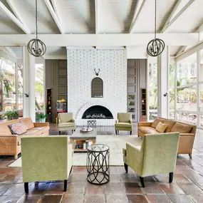 a living room with couches and chairs and a fireplace