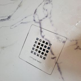 White Marble shower base with matching drain cover