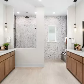 Luxurious primary bathroom with dual vanities