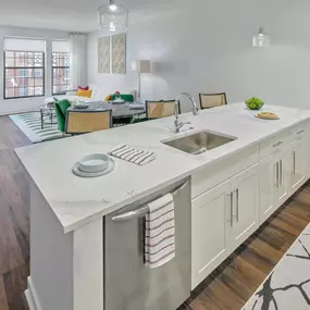 an open kitchen with a large island and a living room