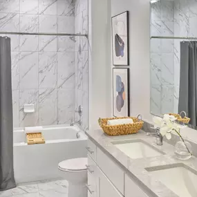 a white bathroom with a toilet and a tub and a sink