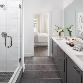 Primary bath includes a large frameless glass shower and dual sink vanity